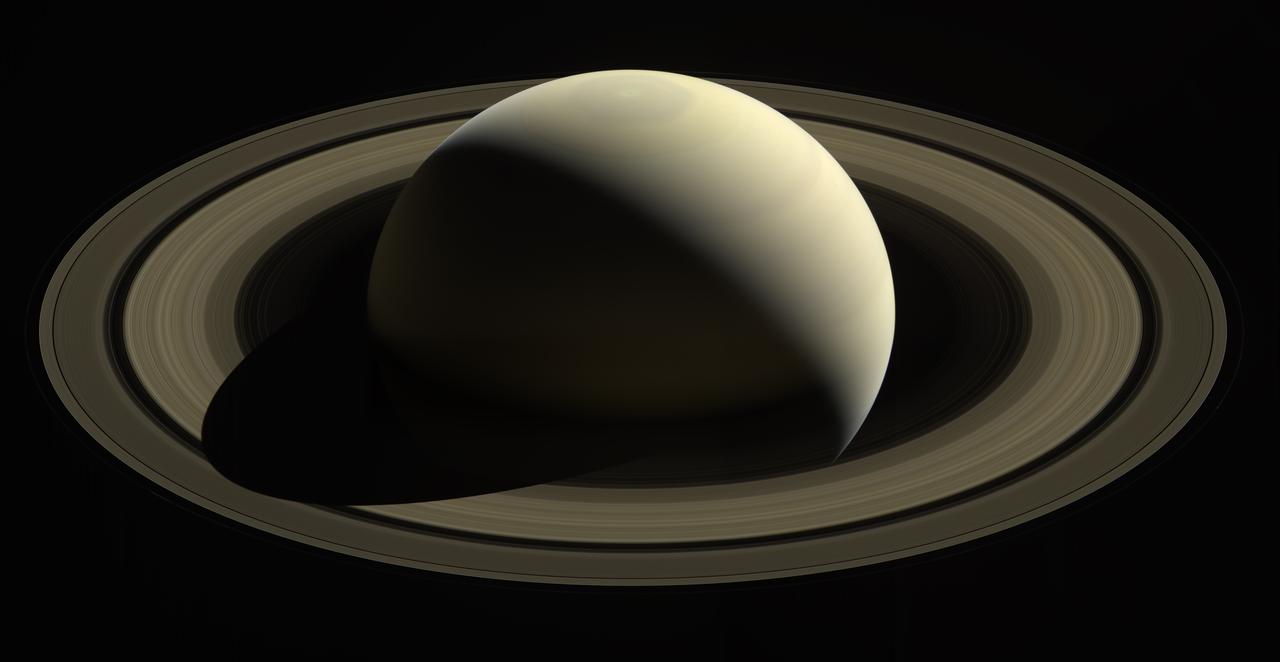 Cassini mosaic of Saturn’s unlit rings from above the north pole, the hexagon still visible on the globe