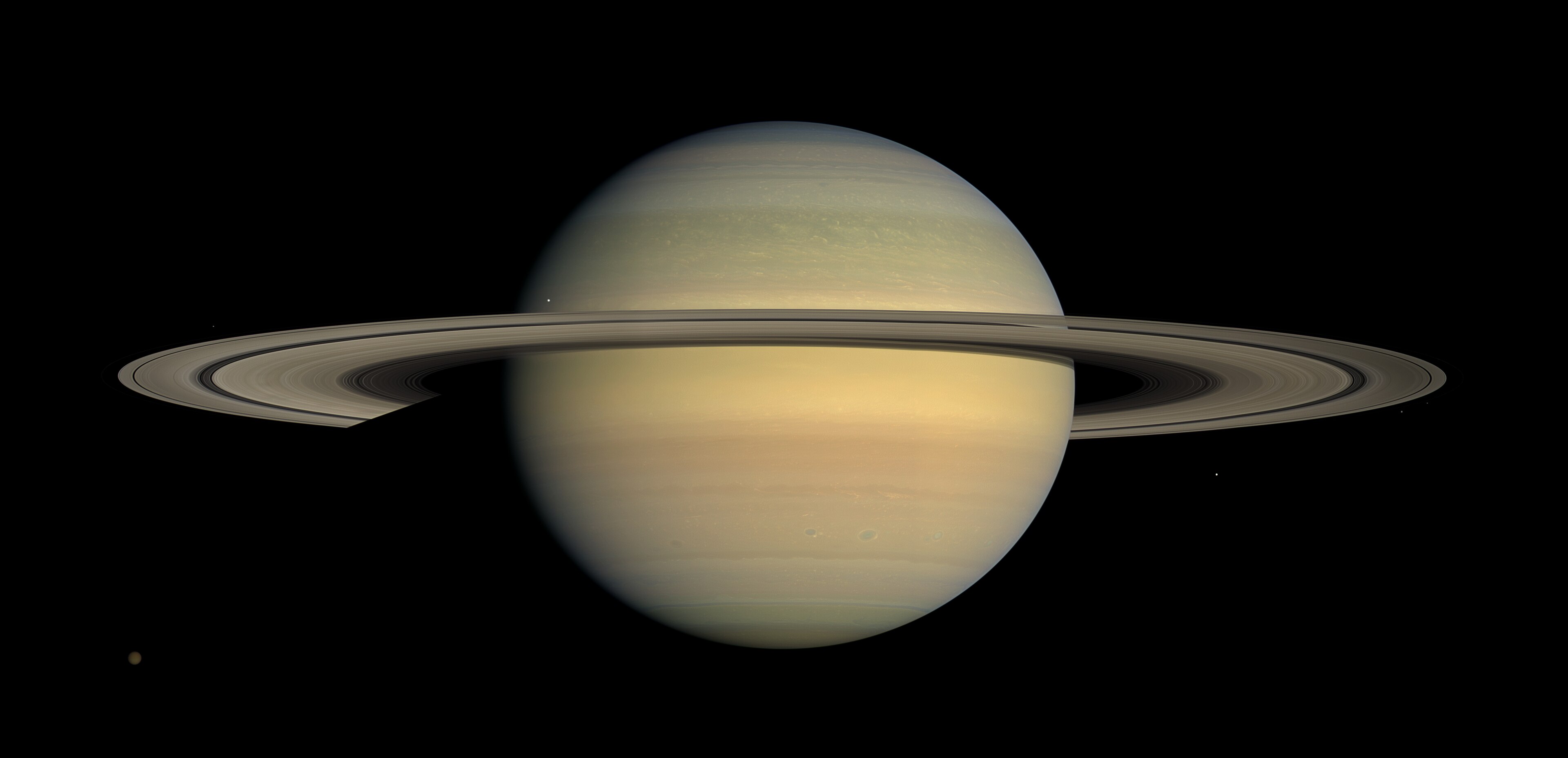 Cassini mosaic of Saturn at equinox, the rings seen nearly edge-on as a thin bright plane